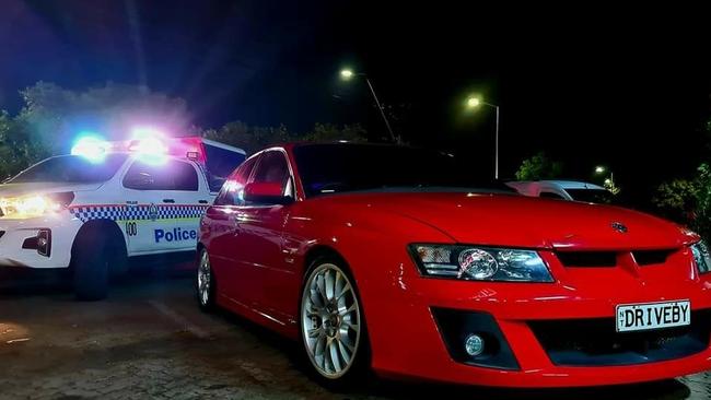 “Local car enthusiast gets a photo with the boys in blue.” Picture: Kane Doughty