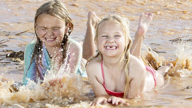 Milly Fitzgerald and Eve Schaefer play in the flooded wheat fields of Pinkawillinie, West of Kimba. Picture Emma Brasier