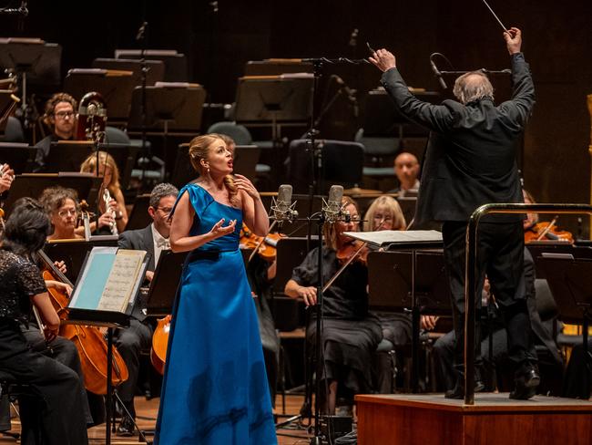 Soprano Siobhan Stagg (left, in blue) performing at Hamer Hall in 2023 with conductor Jaime Martin (right) and the Melbourne Symphony Orchestra, for the 2024 album release 'Debussy & Strauss'. Picture: Laura Manariti