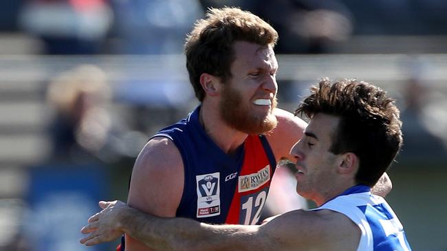 Peter McEvoy of Coburg attempts to break a tackle during the VFL footy: Coburg v Footscray played at Whitten Oval on Saturday 24th August, 2019.