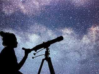 Woman with telescope watching the stars. Stargazing woman and night sky. Picture: Allexxandar