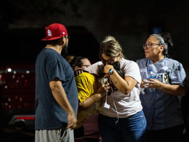 A family grieves outside of the SSGT Willie de Leon Civic Center following the mass shooting at Robb Elementary School.