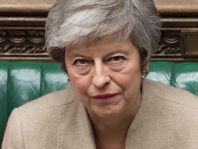 TOPSHOT - A handout photograph taken and released by the UK Parliament on March 29, 2019 shows Britain's Prime Minister Theresa May listening to a speaker during a a debate in the House of Commons on the Government's Withdrawal Agreement Bill, before MPs voted on it. - British MPs on Friday rejected Prime Minister Theresa May's EU divorce deal for a third time, opening the way for a long delay to Brexit -- or a potentially catastophic "no deal" withdrawal in two weeks. (Photo by MARK DUFFY / UK PARLIAMENT / AFP) / EDITORS NOTE THE IMAGE HAS BEEN DIGITALLY ALTERED AT SOURCE TO OBSCURE VISIBLE DOCUMENTS  - RESTRICTED TO EDITORIAL USE - NO USE FOR ENTERTAINMENT, SATIRICAL, ADVERTISING PURPOSES - MANDATORY CREDIT " AFP PHOTO /JESSICA TAYLOR/ UK Parliament"