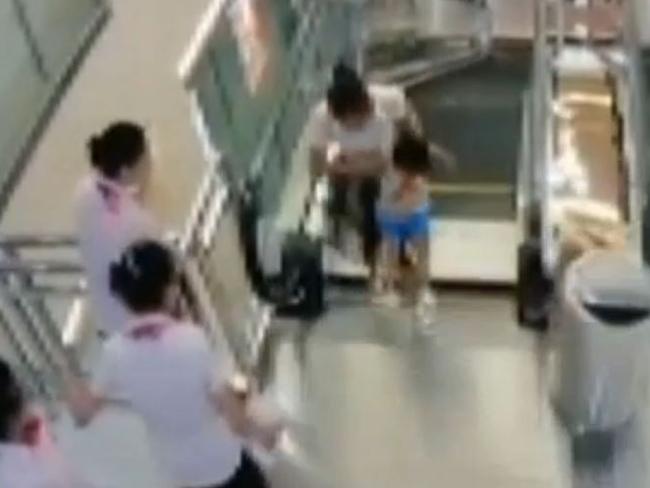 Chinese woman swallowed by escalator dies but saves son | news.com.au ...