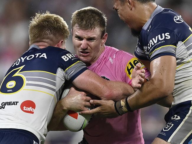 TOWNSVILLE, AUSTRALIA - MAY 10: Luke Garner of the Panthers is tackled during the round 10 NRL match between North Queensland Cowboys and Penrith Panthers at Queensland Country Bank Stadium, on May 10, 2025, in Townsville, Australia. (Photo by Ian Hitchcock/Getty Images)