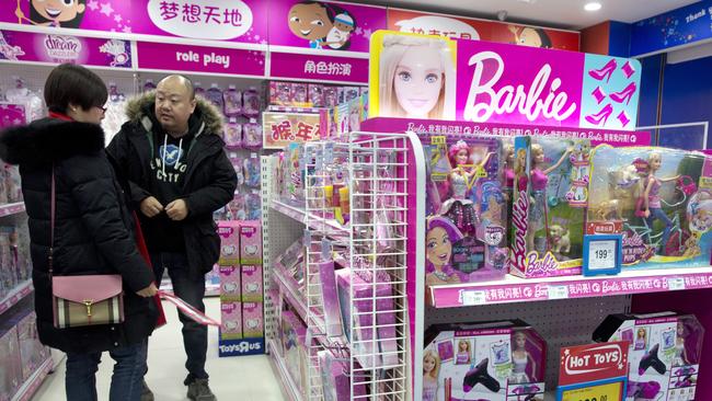 A man and woman look at Barbie dolls at a store in Beijing. Picture: Ng Han Guan