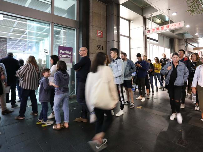 The interstate voters queue splurging out onto the street at the Sun Towers. Picture: Brianne Makin