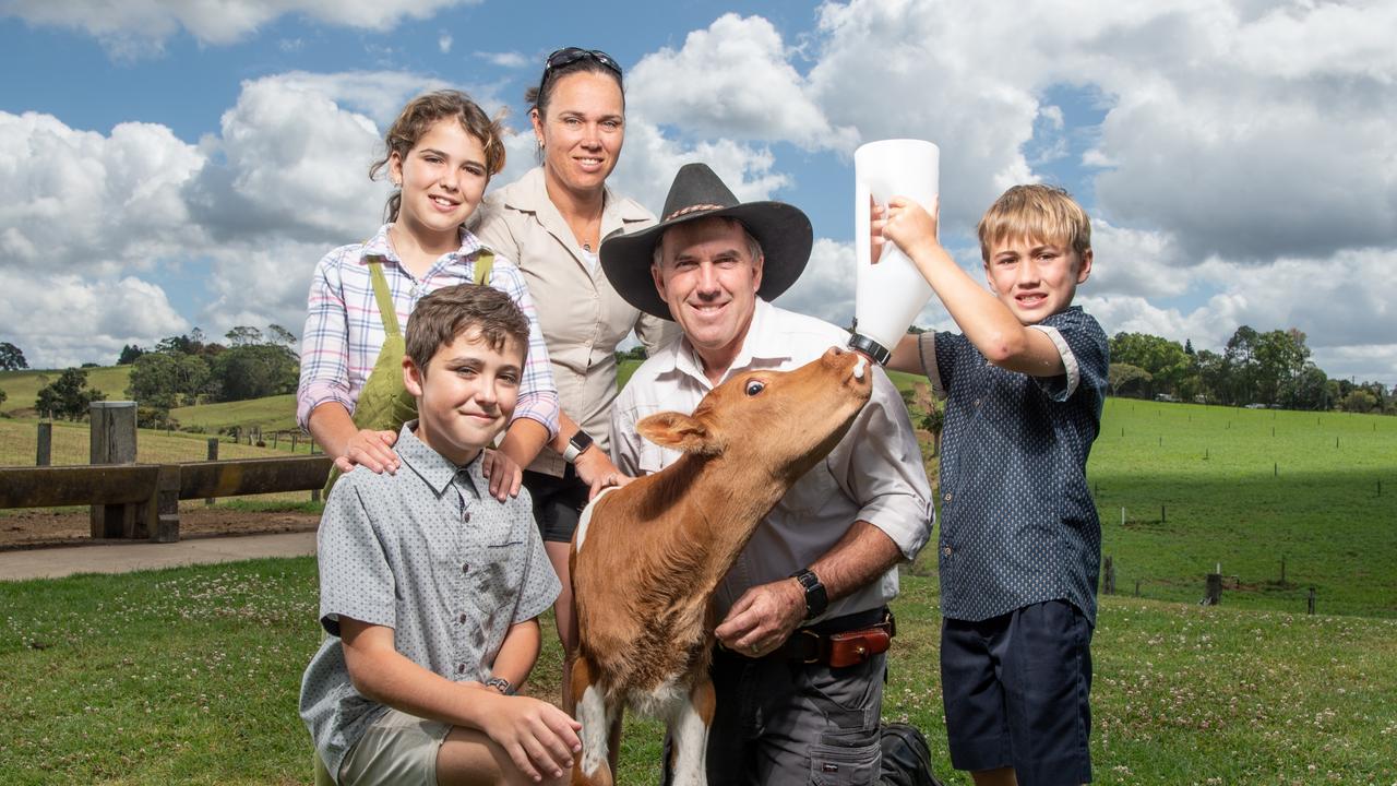 Maleny Dairy owner Ross Hopper with wife Sally and kids Rescue 12, Cheeky 11 and Ruckus 9 feed calf "Hercules". Picture: Brad Fleet