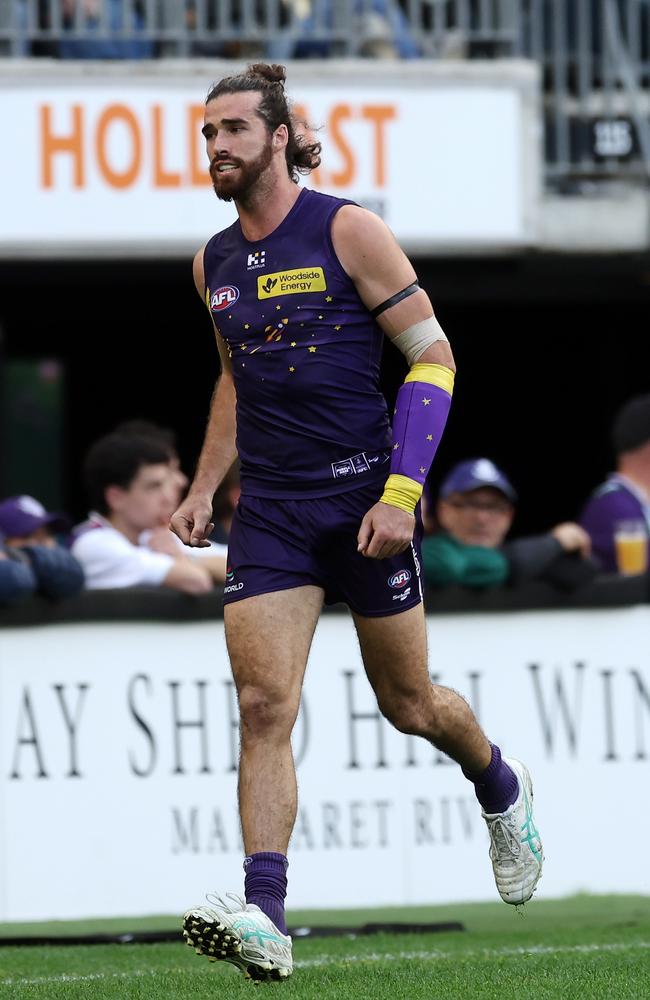 Alex Pearceleaves the field after re-injuring his left arm against the Demons. Picture: Will Russell/AFL Photos via Getty Images.