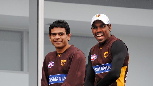 Cyril Rioli (left) and Carl Peterson (right) while at Hawthorn.