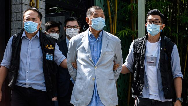 Police lead Hong Kong pro-democracy media mogul Jimmy Lai, 72, away from his home after he was arrested under the new National Security Law in Hong Kong on August 10 Picture: AFP