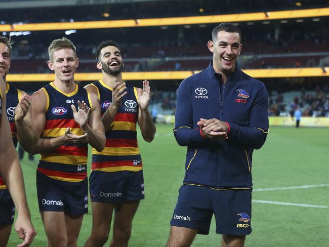 28/04/18 - AFL - Round 6 - Adelaide Crows v Gold Coast Suns at the Adelaide Oval. David McKay, Wayne Milera and Taylor Walker laugh at Andy Otten as he leads the team off after his 100th game. Picture SARAH REED