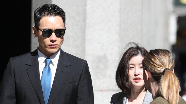 Yunxiang Gao with his girlfriend and lawyer outside the Downing Centre court. Picture: John Grainger