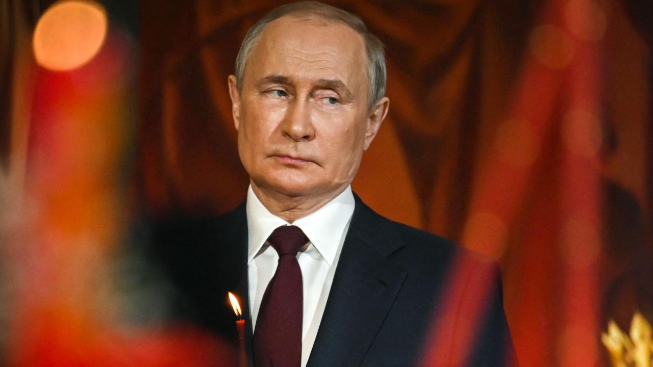 Russian President Vladimir Putin holds a candle during an Orthodox Easter service. Picture: AFP