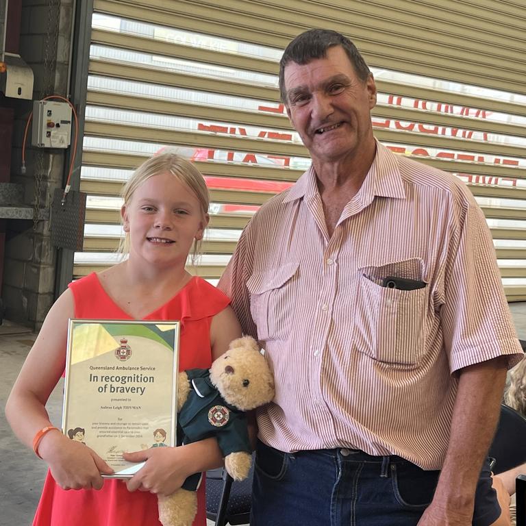 Aubree Tidyman with her grandfather Roland Teakle at an awards ceremony recognising her bravery. Picture: Marcus de Blonk Smith