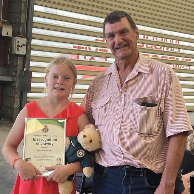 Aubree Tidyman with her grandfather Roland Teakle at an awards ceremony recognising her bravery. Picture: Marcus de Blonk Smith