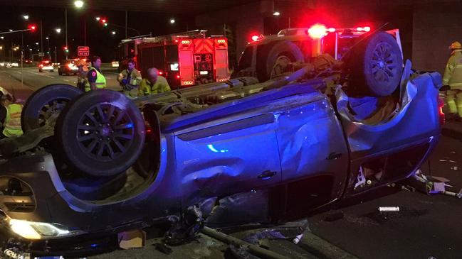 The CFA help clear the crash scene where a ute has ended up on its roof.