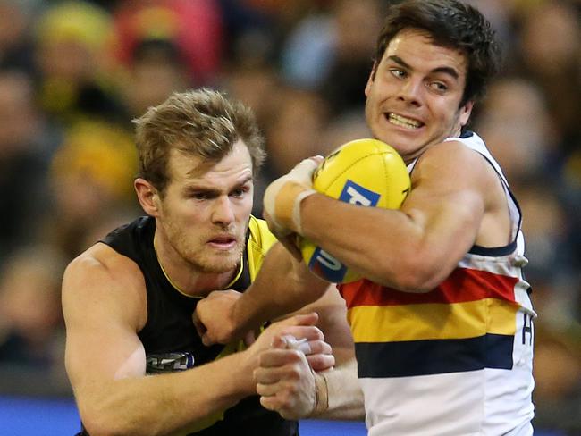 AFL Round 16. 06/07/2018. Richmond v Adelaide at the MCG.  Adelaide's Darcy Fogarty tries to break the tackle of Richmond's David Astbury  . Pic: Michael Klein