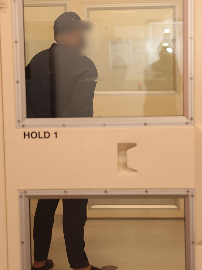 Masood Zakaria in a holding cell after arriving back in Australia on Sunday. Picture: AFP