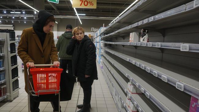 Shoppers peruse empty shelves at a supermarket in Moscow, Russia.