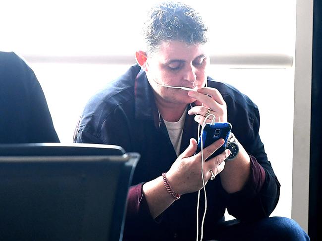 Convicted drug smuggler Renae Lawrence talks on her phone before her Virgin flight to Newcastle. Picture: AAP