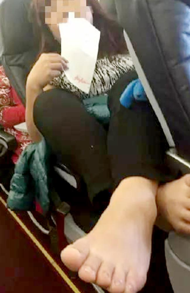 Pic shows: The unnamed middle-aged woman with her foot resting on the armrest. A picture showing a Chinese air passenger placing her feet on the armrest in front of her has gone viral on the internet this week. The affected passenger who took the photo claimed she herself was too afraid to say anything about the middle-aged womanâ€™s poor behaviour, and said that the flight attendants were no help either. Two pictures posted on Chinese microblogging website Sina Weibo showed the etiquette-defying passenger placing both of her bare feet on the armrest of another Chinese woman, surnamed Wu, sitting in front. Wu claims the woman kept her feet there for the entirety of the AirAsia flight from Thai capital Bangkok to Xiâ€™an, capital of northwest Chinaâ€™s Shaanxi Province, only putting her feet down once when going to the lavatory. The disgruntled Wu said she took the opportunity to complain, in English, to a Thai flight attendant while the ill-mannered woman was in the restroom, but said that she was shocked by the response she received. She said the flight attendant took one look at the situation and said without a secondâ€™s hesitation: "Iâ€™m sorry. We canâ€™t do anything â€“ theyâ€™re all Chinese." The dissatisfied Wu then bore with the discomfort of the womanâ€™s feet near her until she landed in Xiâ€™an, and went home. She was later interviewed by a newspaper from the capital Beijing, whose reporters called AirAsia for a comment. The airlines said the incident was not reported by either passenger or crew, so it was unaware of the occurrence. The paper asked Wu why she did not try and speak to the passenger herself and instead tried to get help from the flight attendant in English. The woman responded by saying that she was afraid of being yelled at or worse. Wu said: "The passenger was travelling with a huge group of middle-aged woman just like her. We were only two, and I was afraid my comments would cause an argument." When asked about her decision