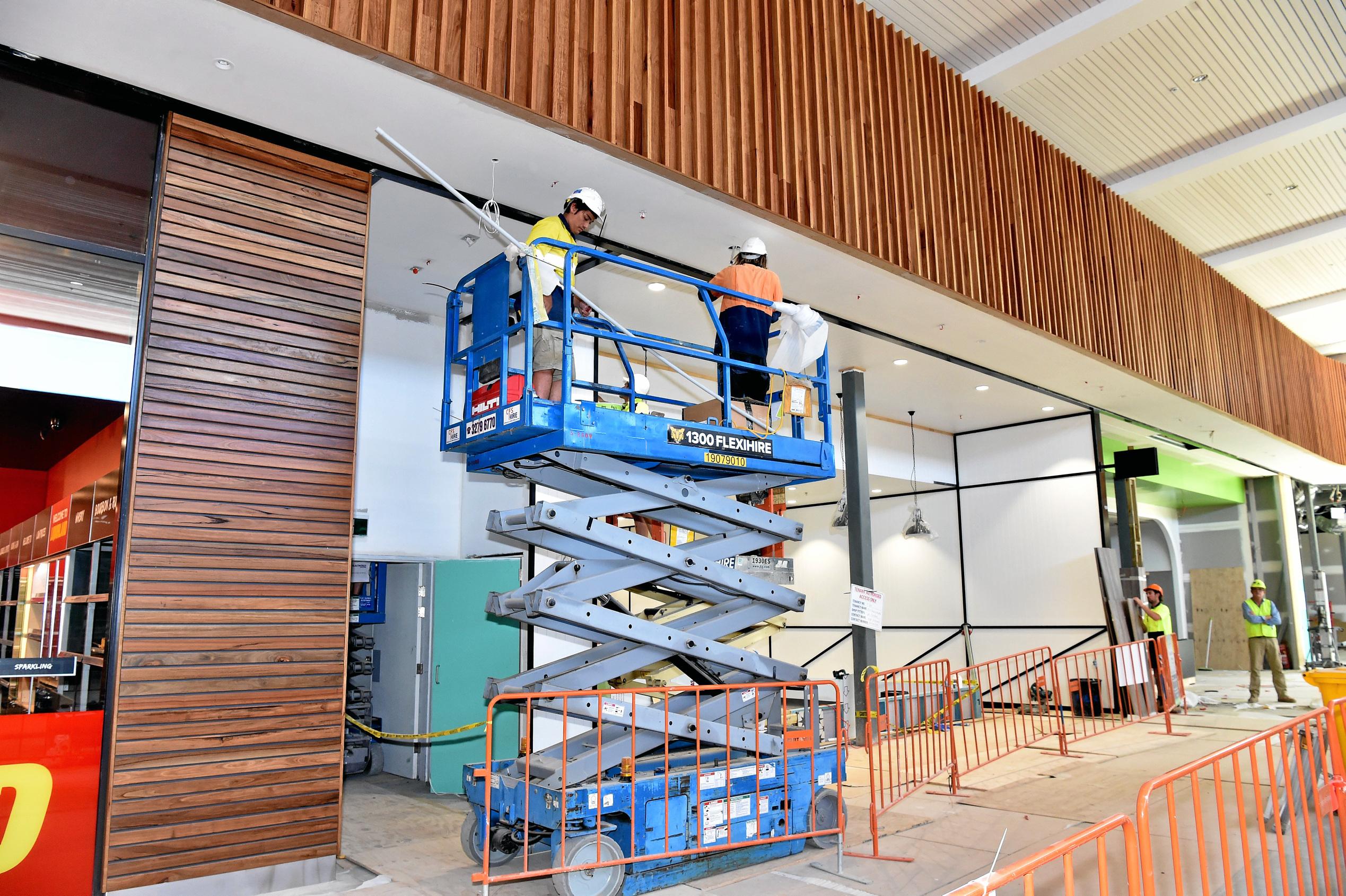 Full steam ahead for the opening of the Stockland Birtinya Shopping Centre. Constuction workers put the final pieces together for the grand opening in a couple of weeks. Picture: Warren Lynam