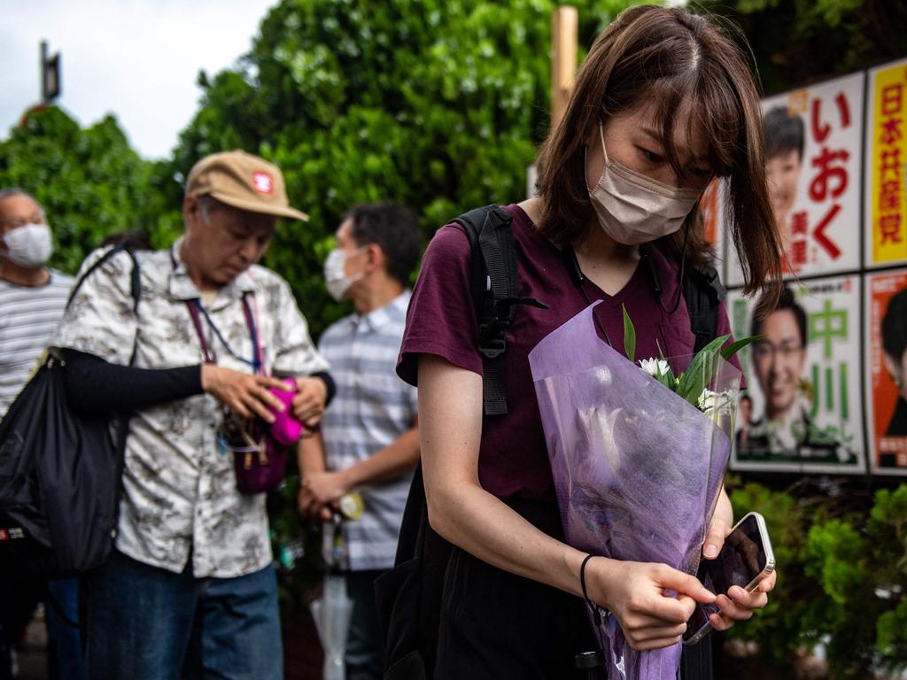 Mourners pay their respects. Picture: Philip Fong / AFP