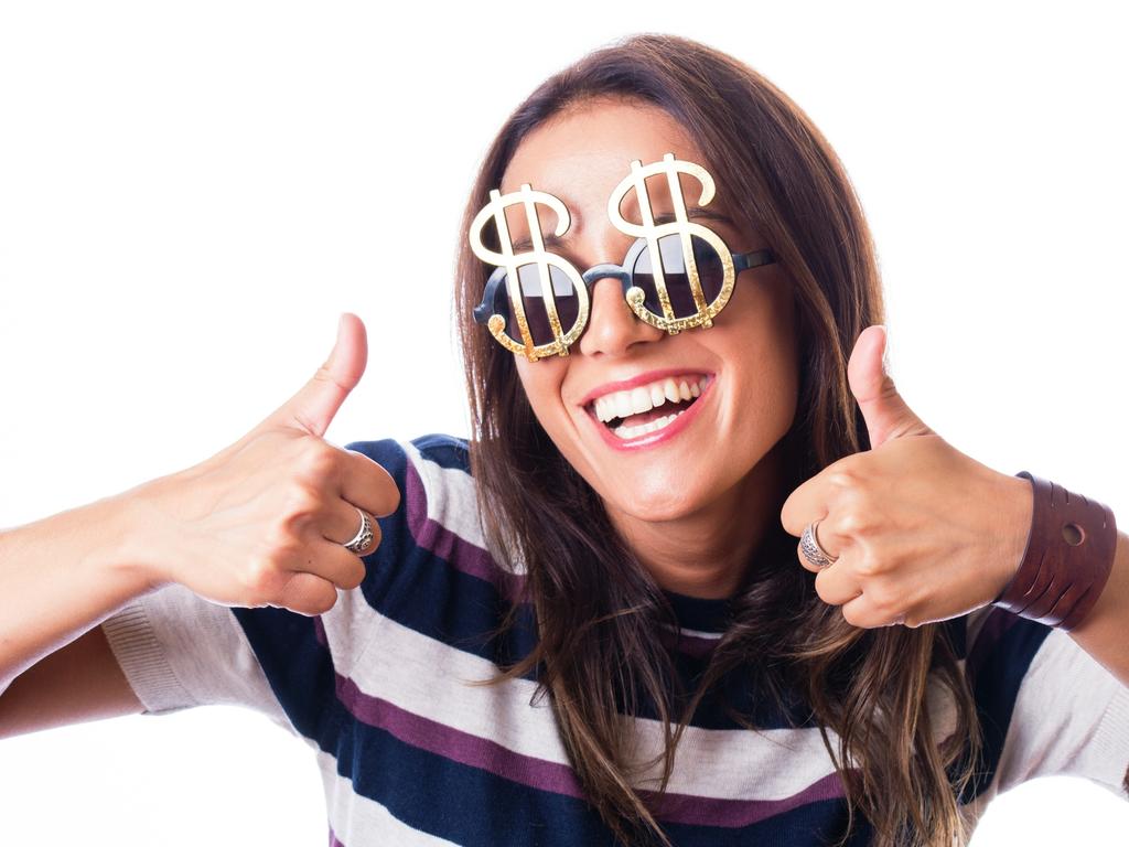 Laughing woman with Dollar sunglasses showing thumbs up with both hand, studio shot isolated on white; money celebration generic