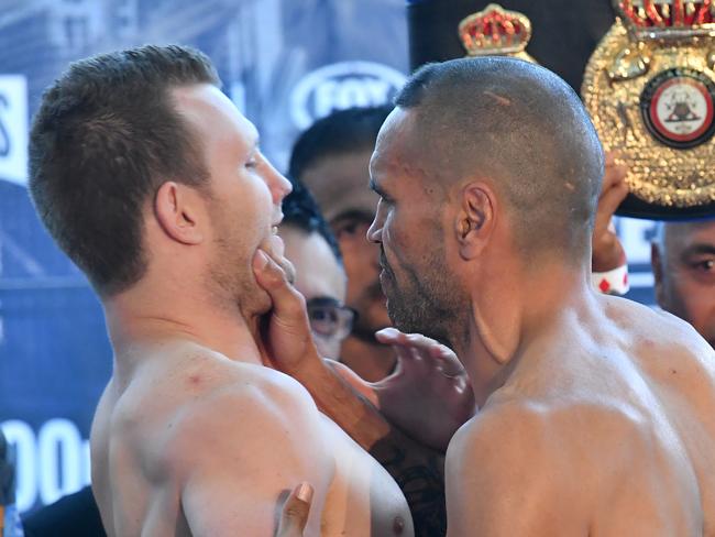 Anthony Mundine goes for the throat at yesterday’s weigh-in. Picture: Darren England/AAP