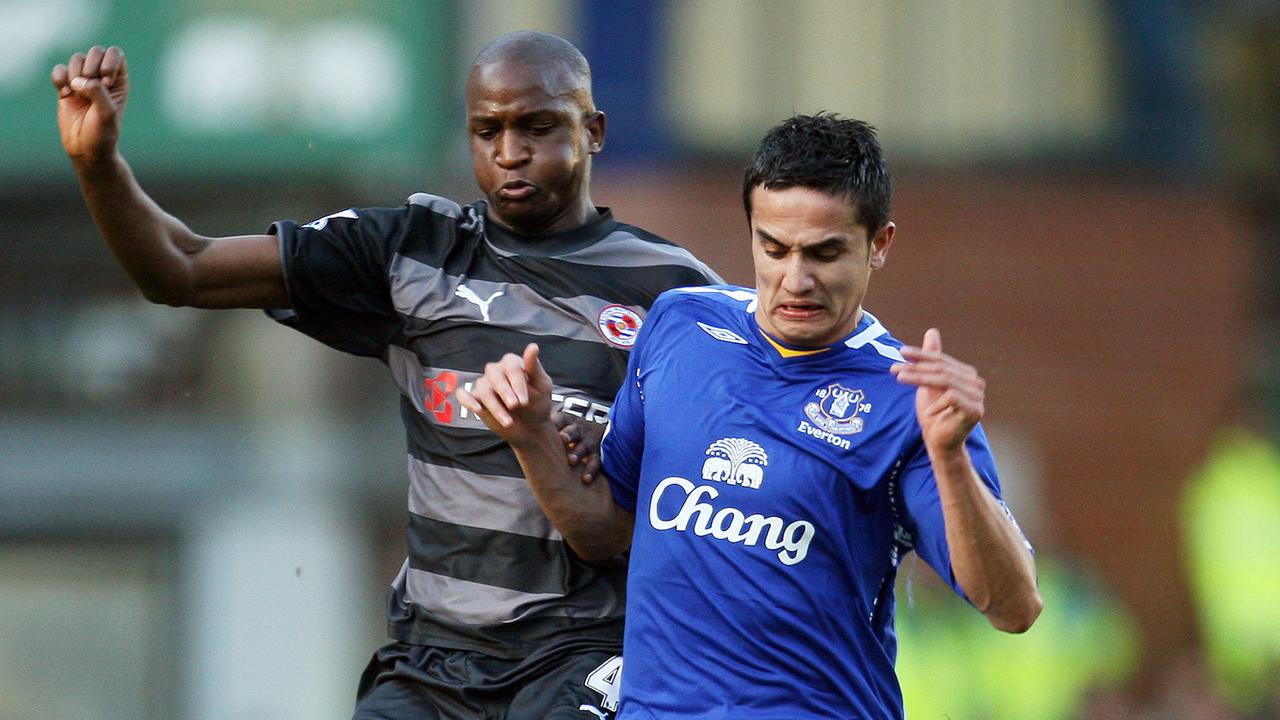 Kalifa Cisse challenges Tim Cahill for the ball.