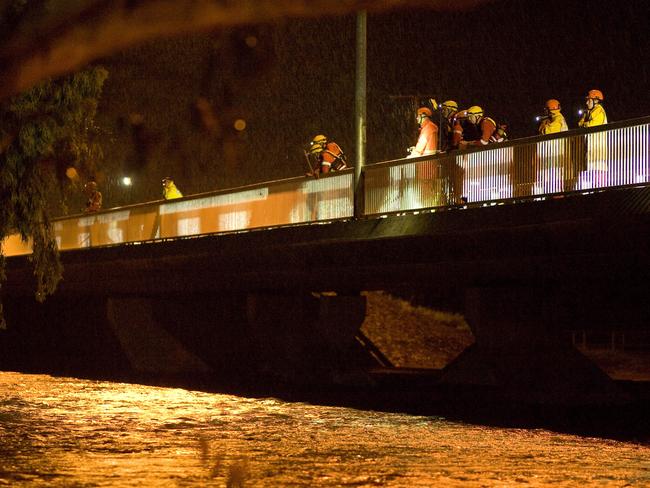 NTES Volunteers line the Stott Terrace bridge with torches searching for the body of a 24-year-old man who drowned. PHOTO: Barry Skipsey