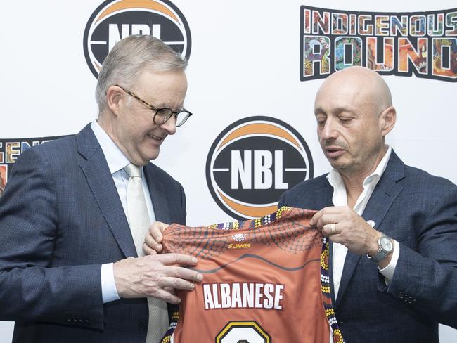 CANBERRA, AUSTRALIA - NewsWire Photos NOVEMBER 29, 2022: NBL launched its Indigenous Round at Parliament House with Prime Minister Anthony Albanese speaking. NBL Owner Larry Kestelman presents Prime Minister Anthony Albanese with his own short in Parliament House, Canberra.Picture: NCA NewsWire / Gary Ramage