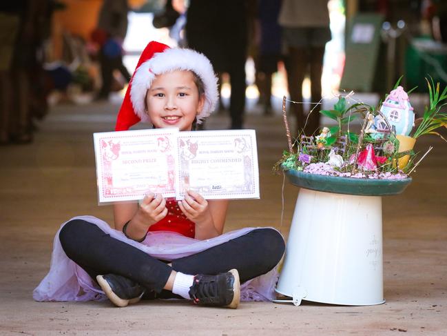 Sylvia Siriotis, 9, a winner in the Horticulture section enjoying day two of the Royal Darwin Show. Picture: Glenn Campbell