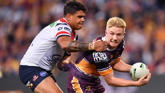 Tom Dearden (right) is tackled by Latrell Mitchell during Brisbane’s Round 10 upset win over Sydney. Picture: AAP