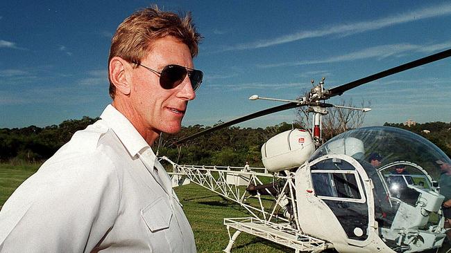 Hijacked pilot Tim Joyce and the helicopter. Pic: Chris Pavlich