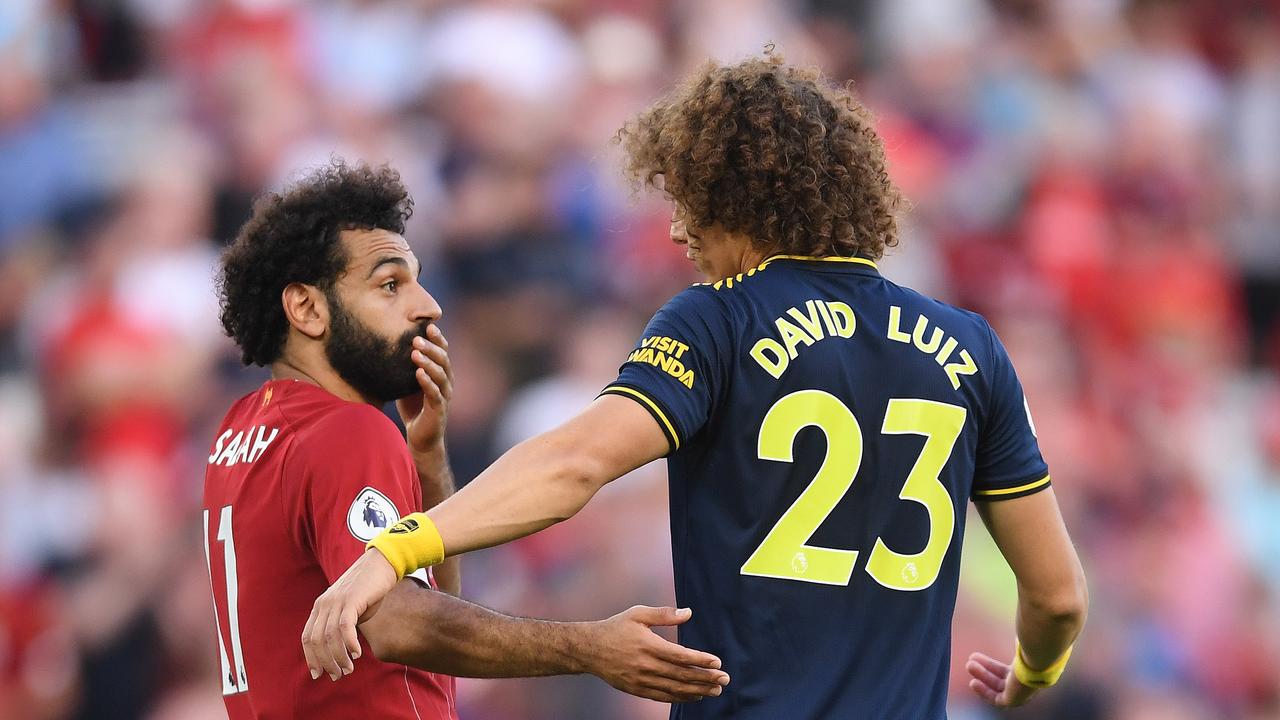 Mohamed Salah chats with David Luiz, who fouled him in a brainless moment. (Photo by Laurence Griffiths/Getty Images)