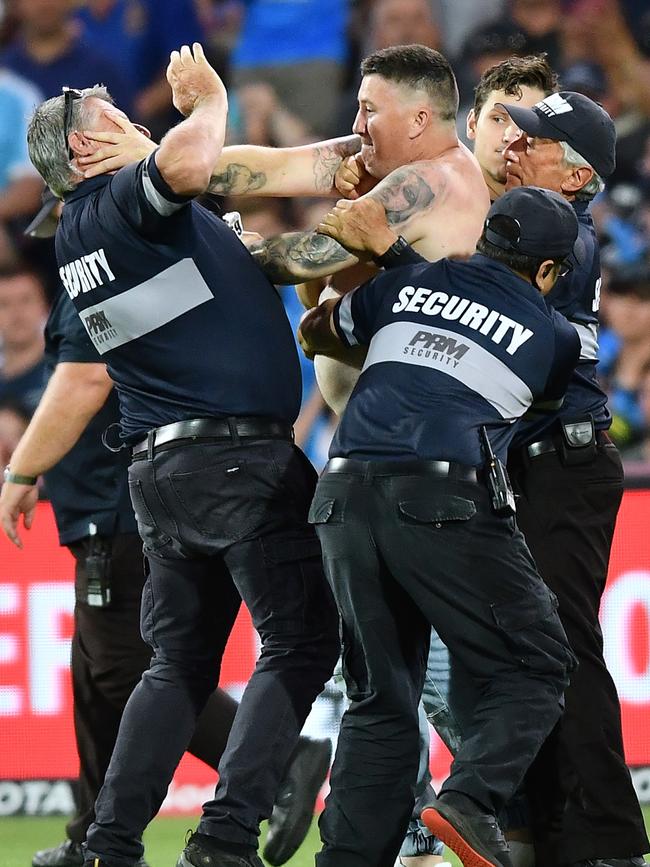 Lawrence Johnstone was photographed hitting one of the security guards while being apprehended. Picture: Mark Brake/Getty Images