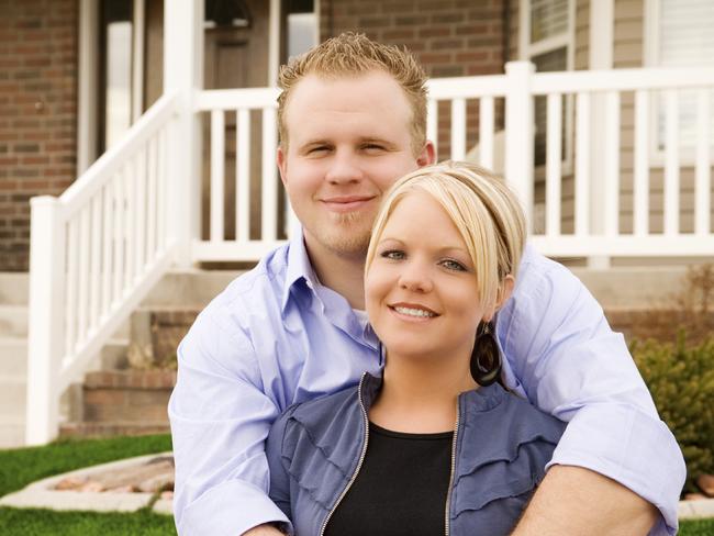 Couple outside a new home and they are paying off their mortgage. Picture: iStock.