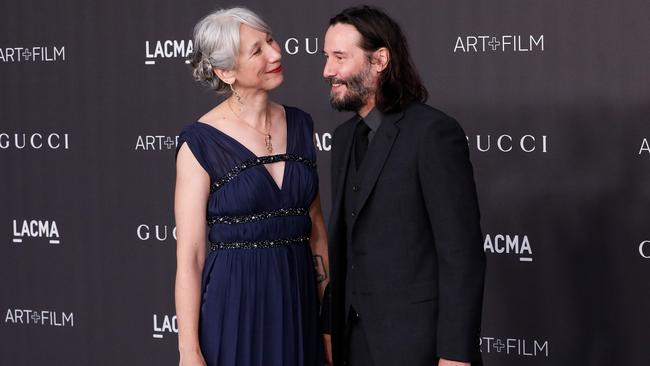 Grant gazed adoringly at Reeves on the red carpet. Picture: Getty Images.