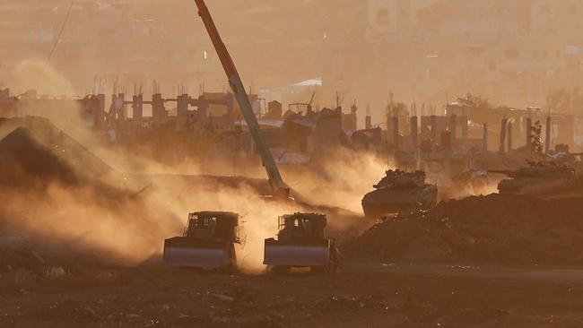 Israeli army vehicles are deployed at a position by Israel's border with the Gaza Strip earlier this month. Picture: AFP