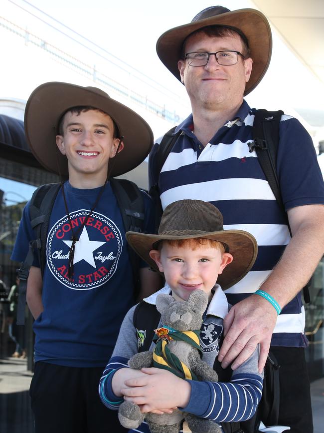 Peter Evans and sons, Tom, 11, and Sam, 6, from Putney weren’t going to miss jumping on the shiny new train. Picture: David Swift