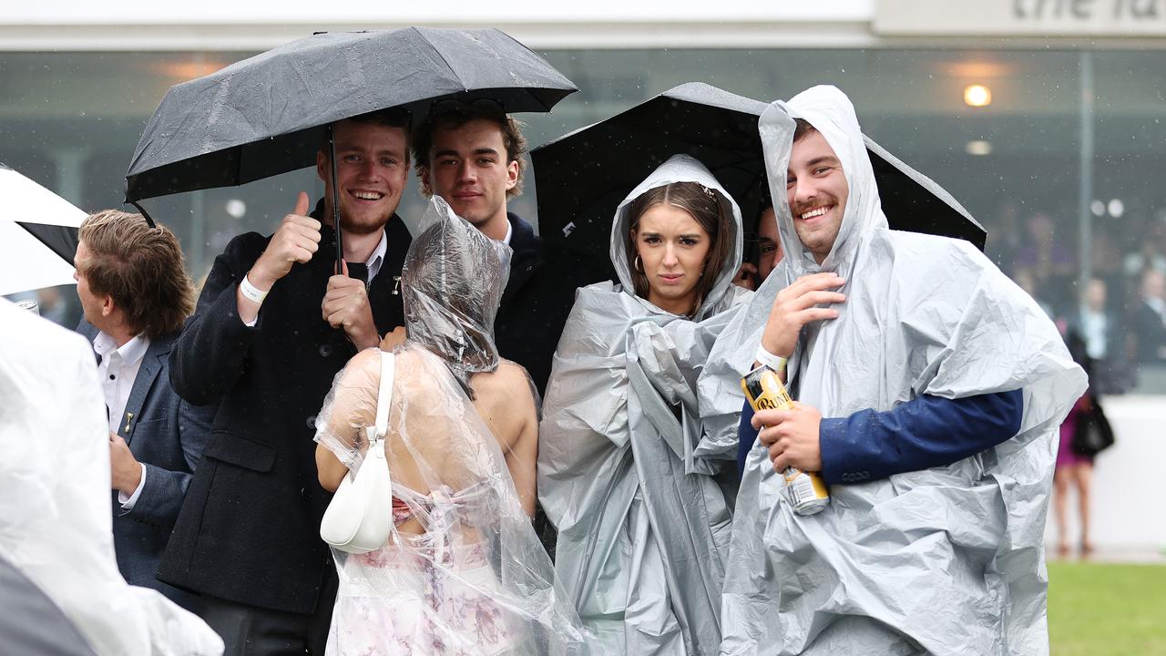 PICTURES: Soggy suits and plastic ponchos dominate 2022 Melbourne Cup