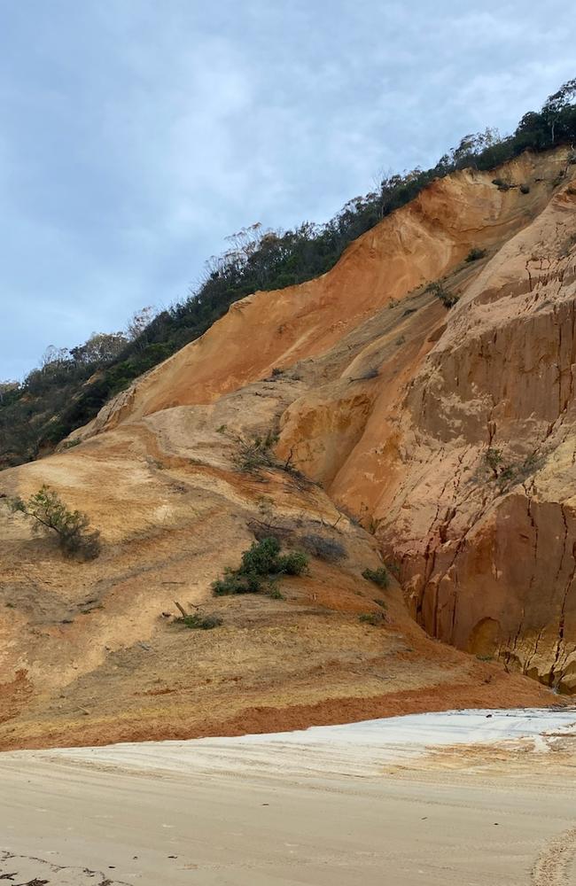 A landslide has brought down tonnes of sand, rocks and trees onto a popular Queensland beach, forcing holiday-makers and beach motorists to use an inland track.