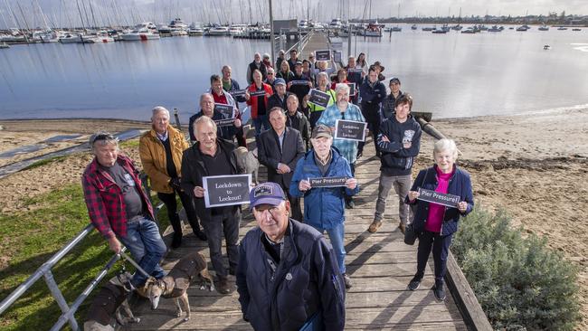 Hampton Pier has been shut and locals are worried it won't reopen. John Burton (front) and group of affected boaters in front of closed pier. Picture by Wayne Taylor 17th June 2020