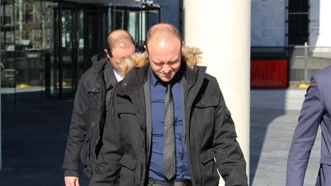 Australian Federal Police officer Joshua Rod Tiffen (front) and his twin brother Kenan Lee Tiffen leave court on an earlier date.