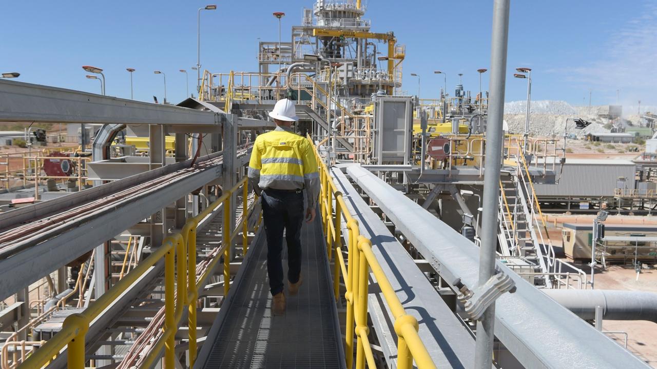 A worker walks across a bridge at the processing plant of the Pilbara Minerals Ltd. Pilgangoora lithium project in Port Hedland, Western Australia. Picture: Carla Gottgens/Bloomberg