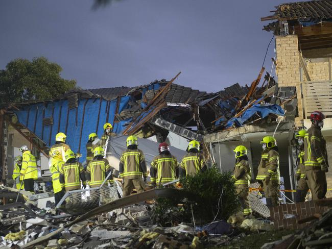 Fire and Rescue crews work through debris at a home explosion in Whalan. Picture: Jeremy Piper