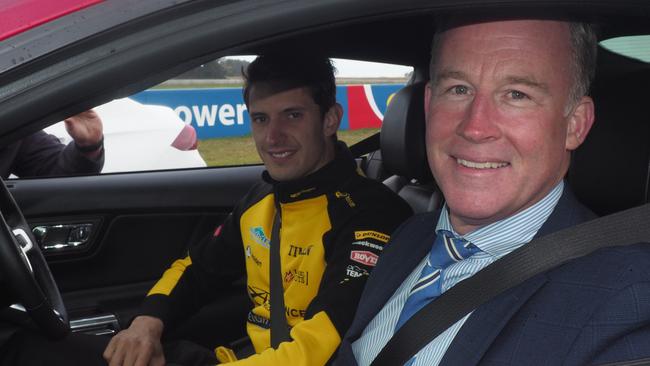 Supercars driver Nick Percat and Premier Will Hodgman prepare to take a lap of the Symmons Plains track after the announcement of a new deal keeping the Supercars event in Tasmania until 2023.