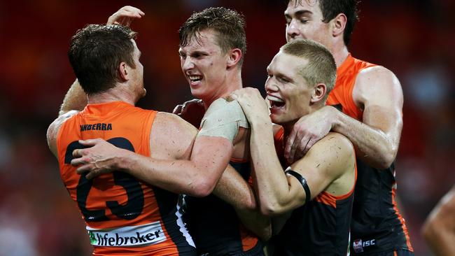 AFL Round 1 - Greater Western Sydney (GWS) Giants v Sydney Swans at Spotless Stadium in Homebush. Lachie Whitfield (2nd from L) celebrates with team mates after kicking a goal.